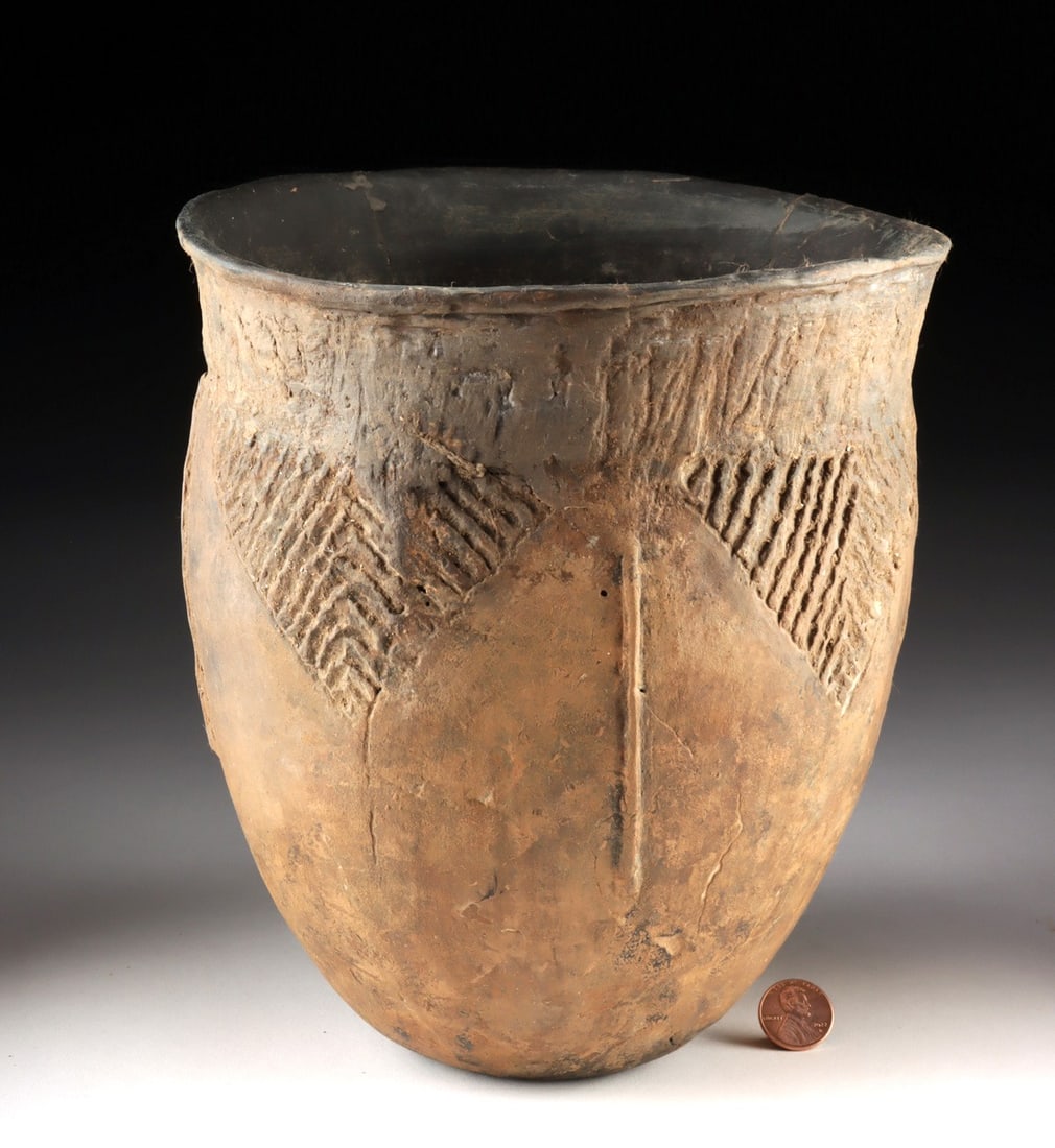 Mississippian Brownware Pottery Jar: Native American, Southeastern or Midwestern United States, Mississippian / Caddo culture, ca. 1400 to 1600 CE. A hand-built pottery jar exhibiting a planar base, an egg-shaped body, and a flared rim s