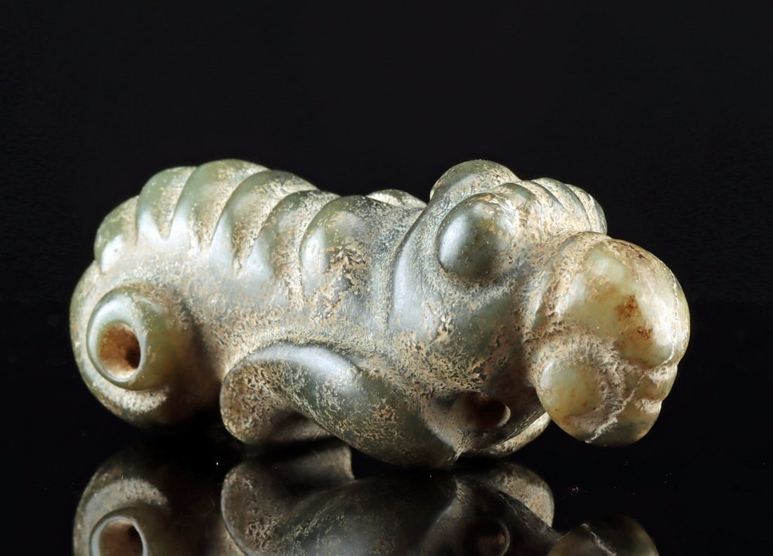 Chinese Neolithic Hongshan Jade Silk Worm: East Asia, China, Northeast region, Hongshan culture, ca. 3500 to 3000 BCE. A wonderful nephrite jade pendant in the form of a silk worm with a segmented body, a scrolling tail, bulging eyes, and a cu
