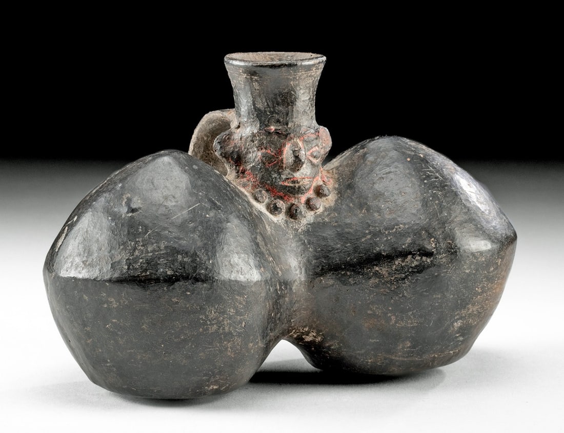 Chimu Blackware Spouted Vessel w/ Male Head: Pre-Columbian, North/Central Coast of Peru, Chimu culture, ca. 1100 to 1470 CE. A hand-built and highly burnished blackware pottery jar of twin-lobed form, each container with a carinated midsection a