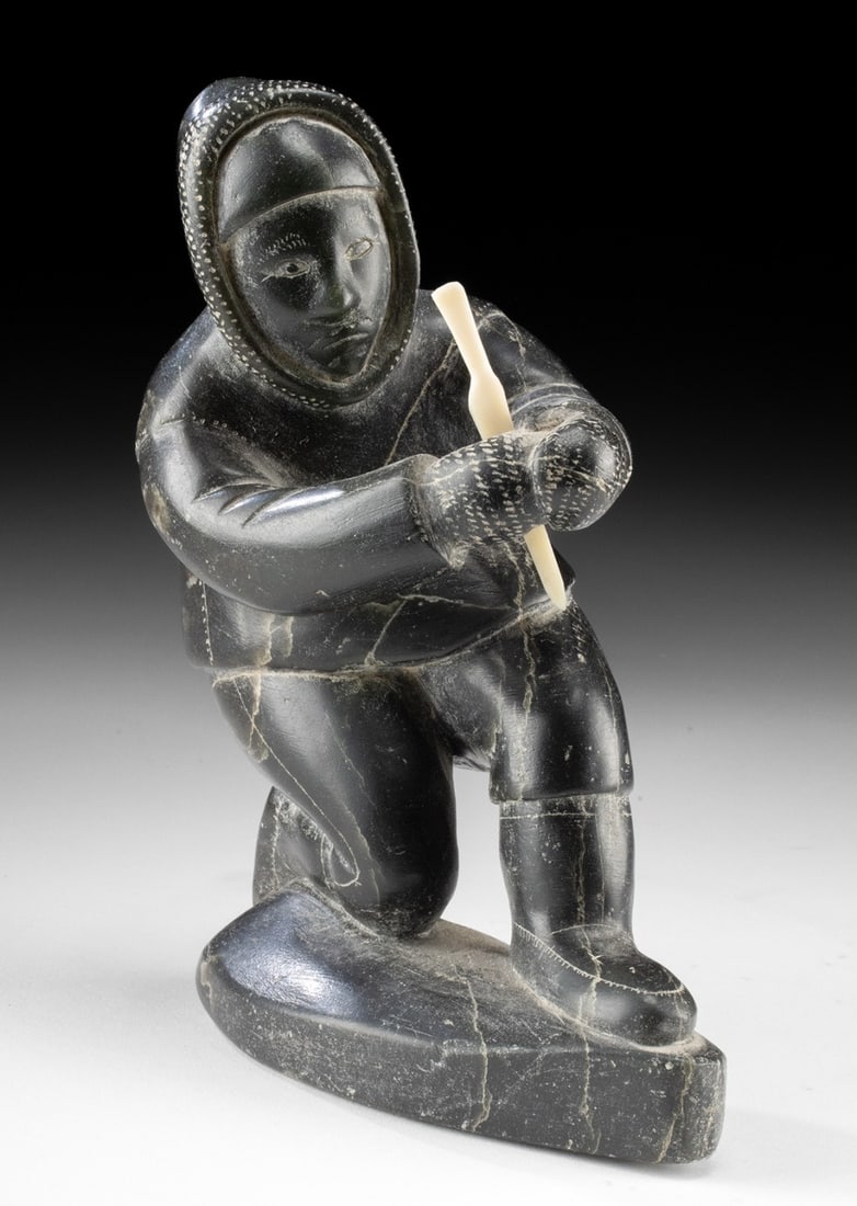 1950s Inuit Soapstone Kneeling Hunter Parka Bone Knife: Native American / First Nations, Northwestern United States, Alaska, or Canada, Inuit culture, ca. mid-20th century CE. A soapstone carving depicting a hunter dressed in a thick parka, shown kneeling 