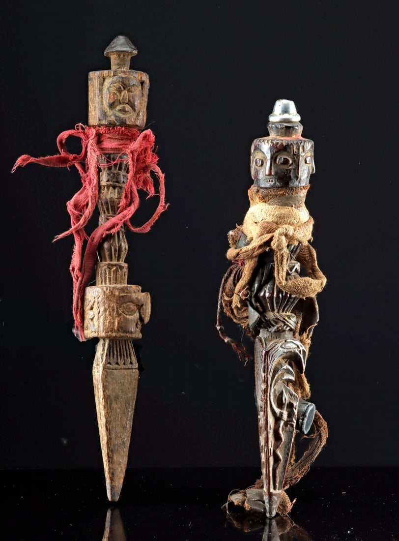 Two Tibetan Buddhist Wood Phurba Knives: Central Asia, Tibet, ca. early to mid-20th century CE. A pair of wooden phurbas, also known as ritual "magic daggers," crafted in the traditional three-sided stake form with cotton cords wrapped aroun