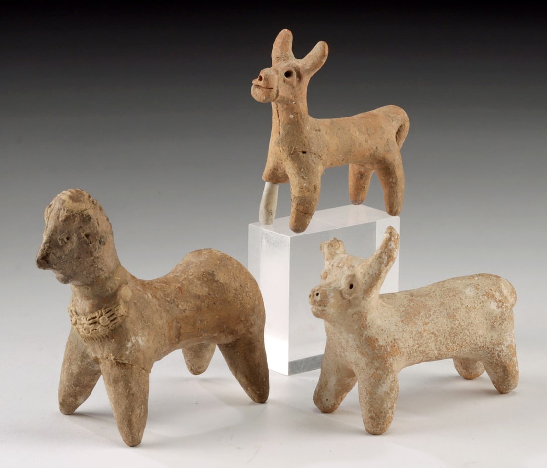 3 Syro-Hittite Pottery Quadrupeds - 2 Bulls + 1 Hybrid: Ancient Near East, Levant, Syro-Hittite, ca. 2nd millennium BCE. A charming group of three Syro-Hittite terracotta quadrupeds, each modeled with distinctive stylization and symbolic detail. Two repres