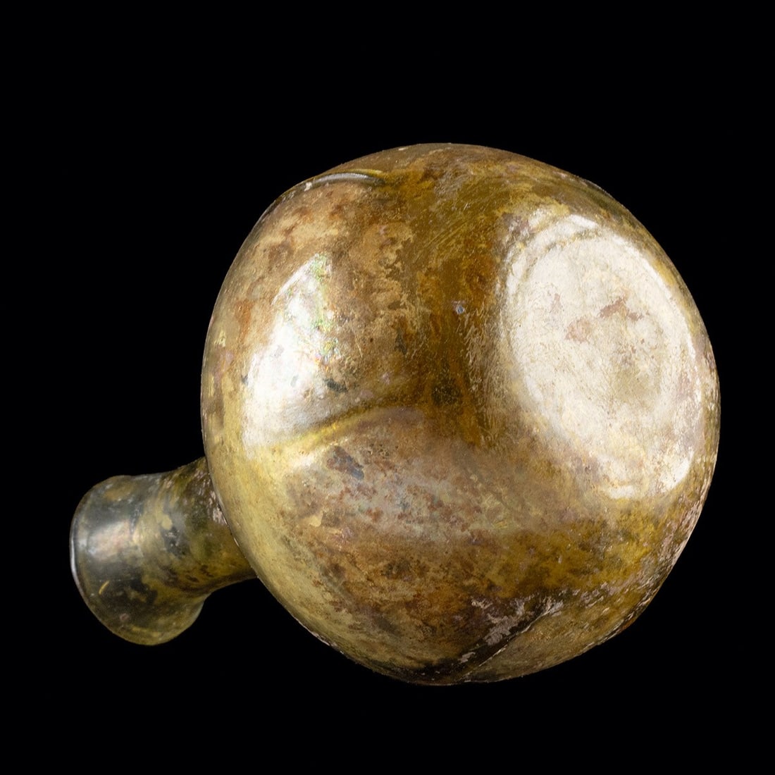 Roman Amber Glass Bottle: Roman, Imperial Period, ca. 3rd to 4th century CE. A lovely free-blown glass flask with a fabulous coloration. The semi-translucent vessel boasts a spherical body with six raised, evenly-spaced ribs, 