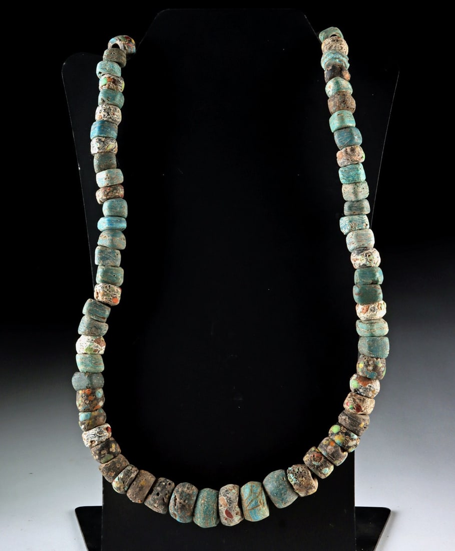 Hebron Salt Glass Trade Bead Necklace Strand: Near East, Israel, Hebron, ca. 19th century CE. A collection of over 70 Hebron glass beads strung as a necklace. These distinctive beads were produced from salt glass using winding or molding techniqu