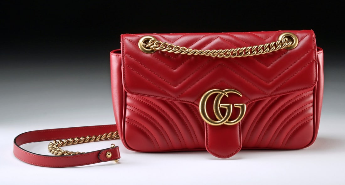 Gucci Marmont Small Red Matelasse Leather, 2017: Gucci, Italy, ca. 2017 CE. A Gucci Marmont small flap bag crafted in red matelasse leather with the signature chevron quilting and a heart motif at the back. The front flap is accented by the brand's 