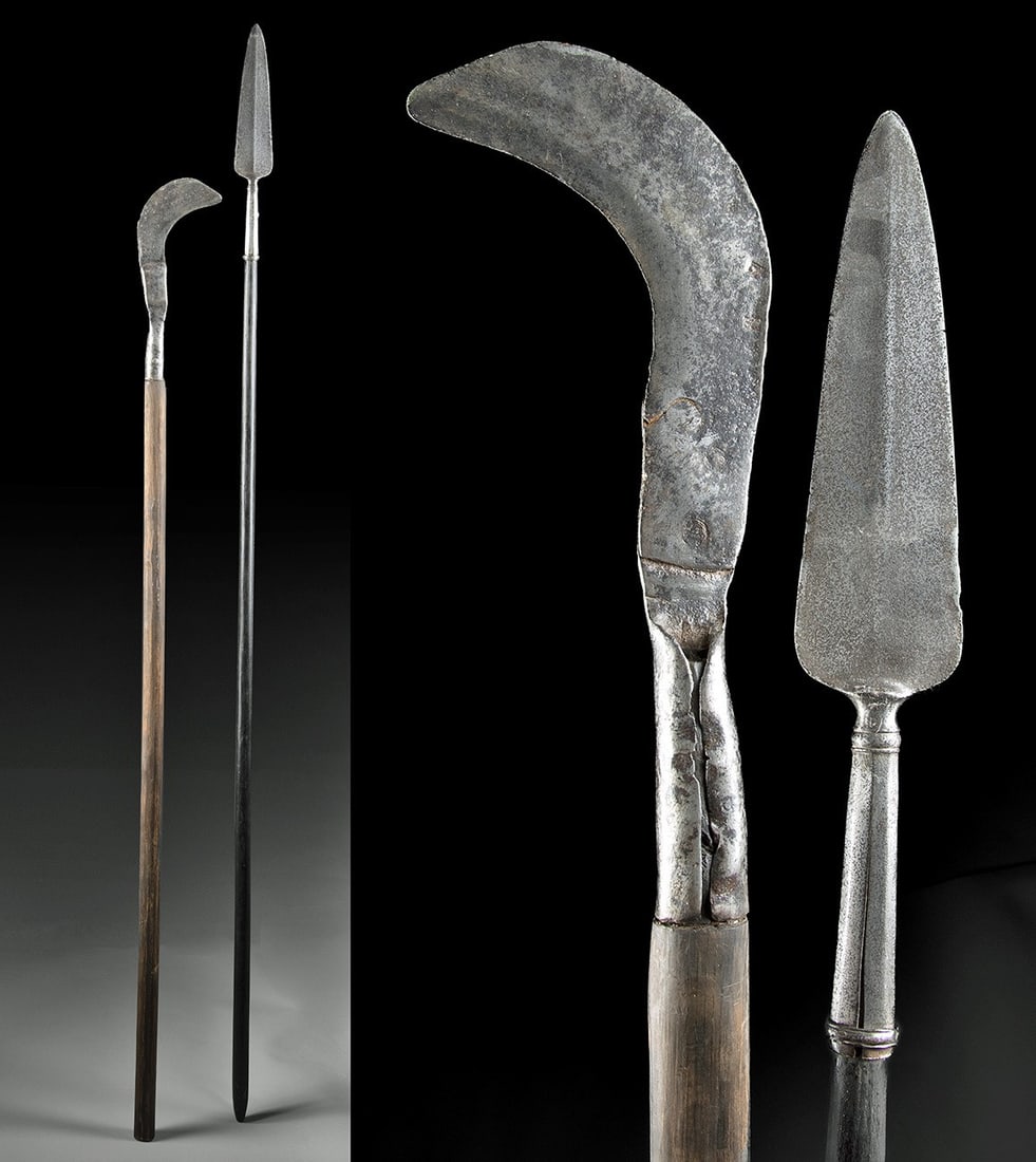 18th C. European Iron Polearms - Spear + Billhook: Western Europe, likely Germany, England, or France, ca. 17th to 18th century CE. A pair of iron polearms with lengthy wood shafts. The spear has a lanceolate blade with a tubular socket, and a billhoo