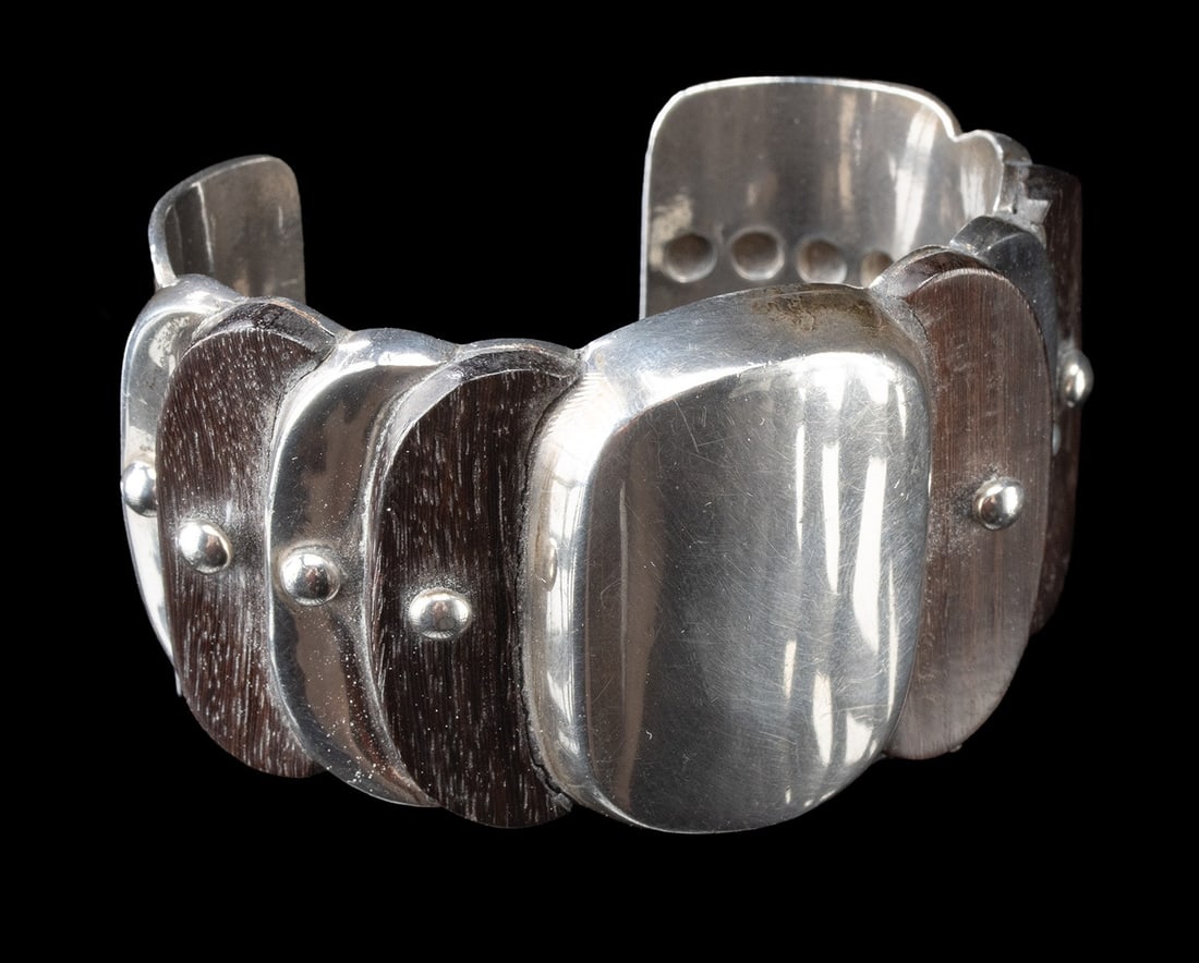 William Spratling Taxco Sterling Silver / Rosewood Cuff Bracelet: A bold, sculptural cuff by William Spratling, this striking bracelet pairs gleaming sterling silver with deep rosewood in a design that feels both architectural and effortlessly wearable. The form is 