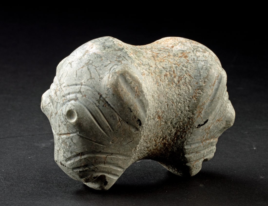 Colima Stone Janus-Headed Dog Mace Head: Pre-Columbian, West Mexico, Colima., ca. 300 BCE - 300 CE. Skillfully carved from a single piece of stone, a marvelous janus canine-headed mace. Each puppy's visage presents bulging eyes, a protruding