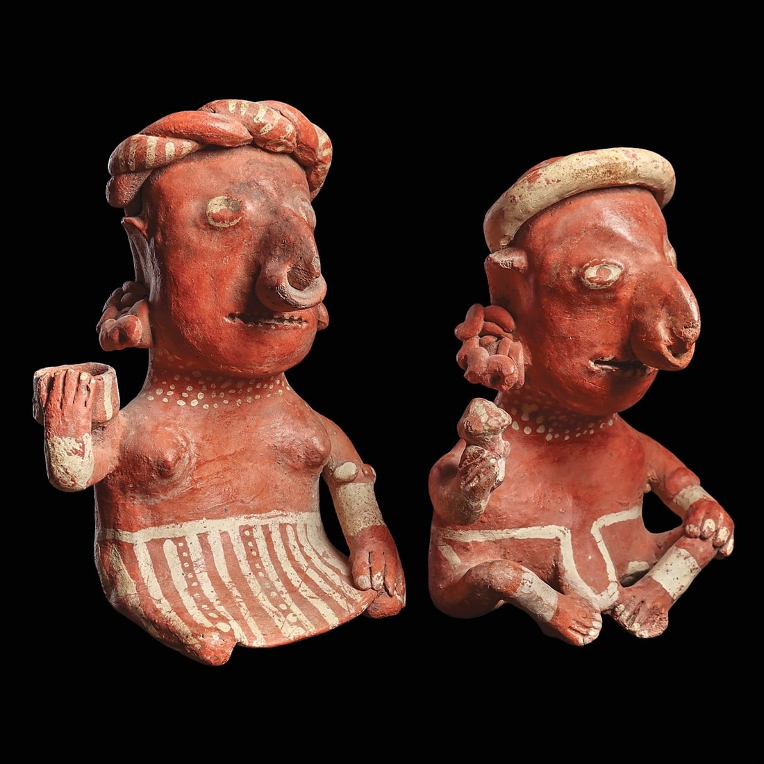 Nayarit / Ixtlan del Rio Matching Male & Female Figures: Nayarit, ca. 100 BCE - 250 CE. Hollow orangeware pottery male and female seated figures. The female wears a knee length striped skirt and holds a bowl on her right shoulder. The male rests his left ha