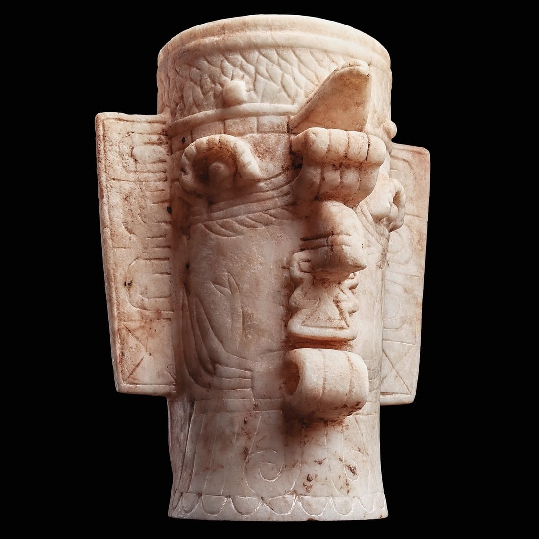 Exceptional Maya Marble Chac Vase: Honduras. Ulua Valley region, ca. 600 - 800 CE. Carved white marble tapered cylindrical vase depicting the Maya god Chac, of rain, thunder, and lightning, having large angular flanges decorated with a