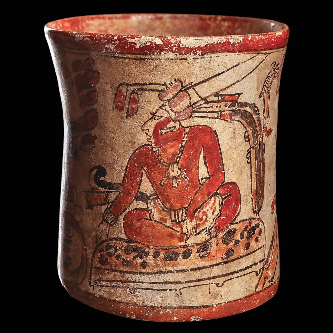 Maya Polychrome Decorated Palace Scene Cylinder Vase: Maya regions, ca. 500 - 800 CE. Fine, polychrome decorated pottery cylinder vase, with an audience scene of a young lord seated on a jaguar skin covered pillow with three attendants around him. Before