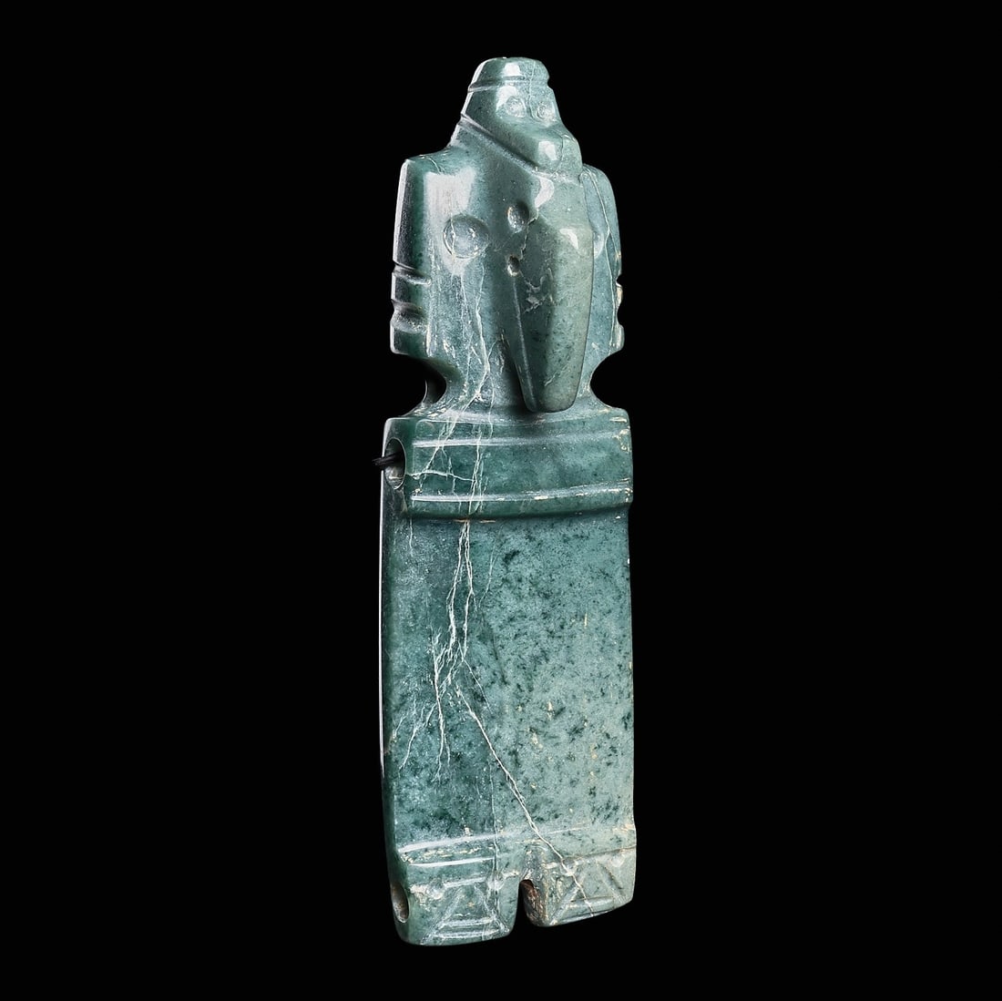 Costa Rican Jade Owl Deity Pendant: Costa Rica, ca. 500 - 1000 CE. Carved blue-green jade owl deity pendant, having a long rectangular slab type body, large squared head with a long tapered beak, small drilled eyes, and a raised zoomorp