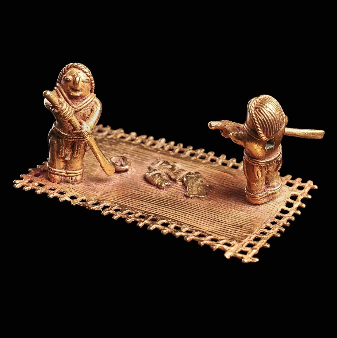 Exceptional Calima Gold Men on Raft: Colombia, ca. 800 - 1500 CE. Fine gold small raft with two standing fishermen holding paddles, three fish lying near the center of the raft and a small bowl. Finely detailed raft having a multi reed f