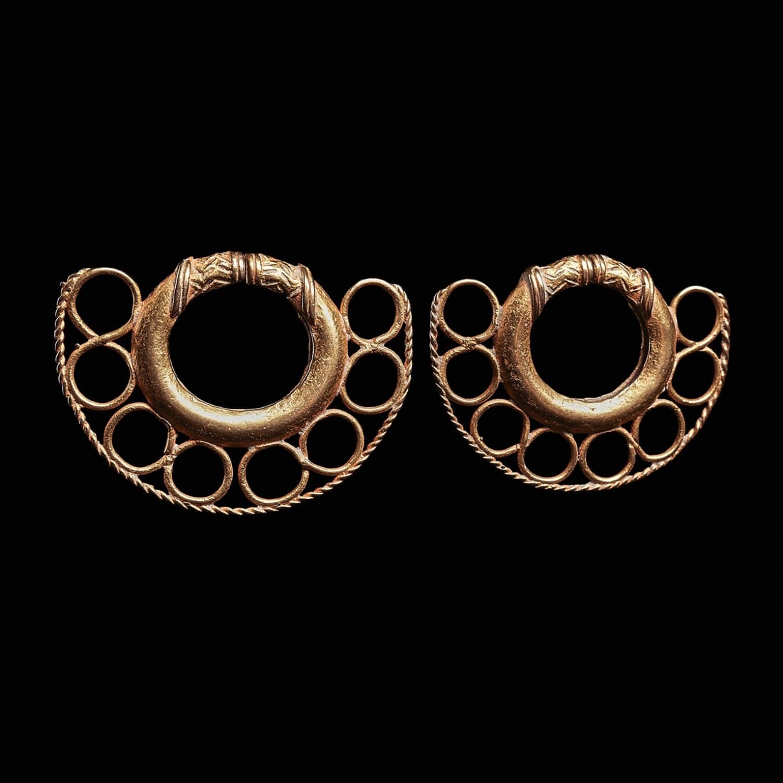 Tairona Large Gold Pair of Ear Ornaments (2): Rio Magdalena, Colombia, ca. 800 - 1400 CE. Fine pair of matching gold ear ornaments, having an outer crescent form border, composed of a rope twist heavy gold wire outer edge and and eight large hoop
