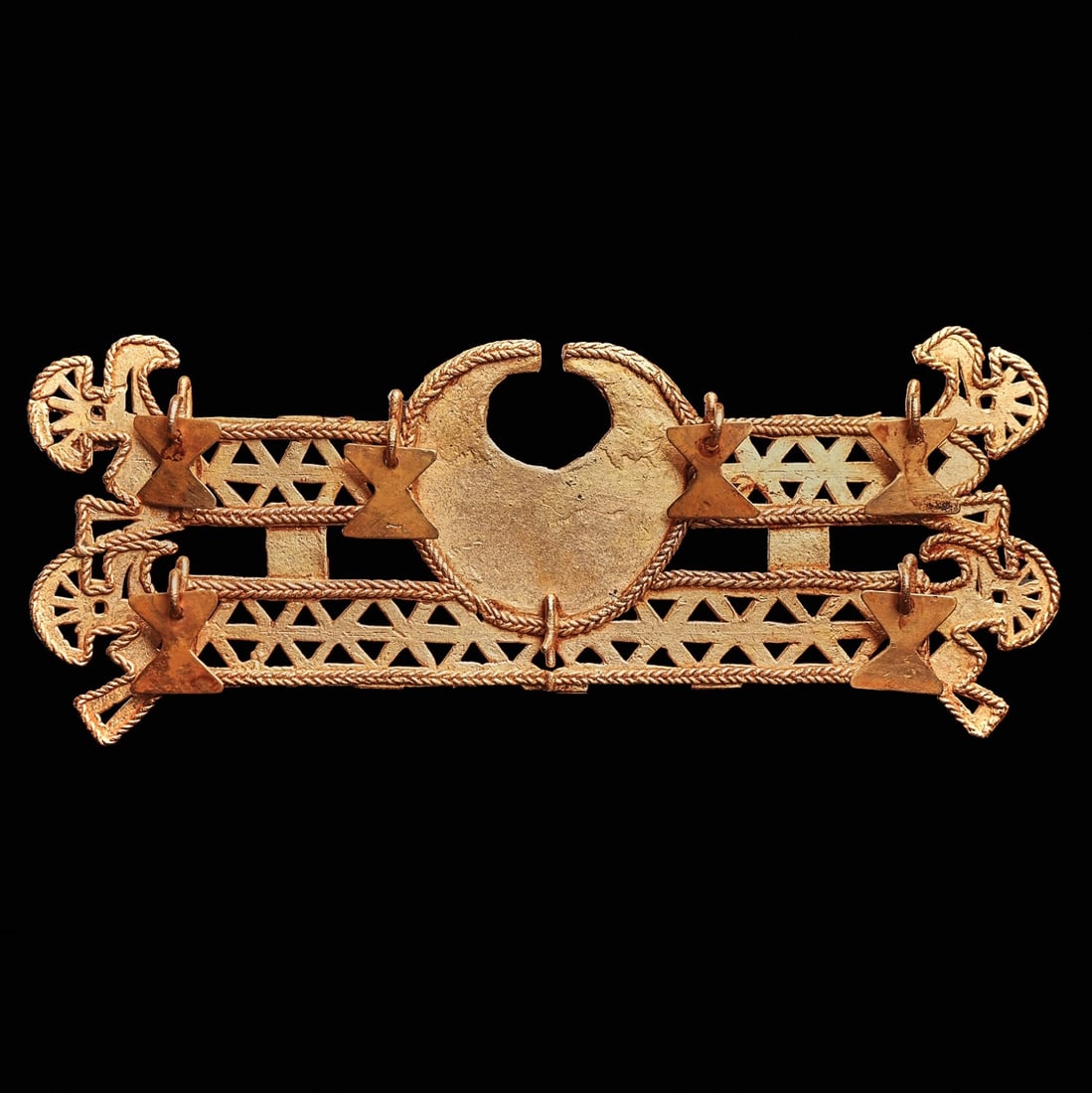 Muisca Fancy Gold Nose Ornament: Colombia, ca. 1000 - 1550 CE. Large gold nose ornament, of rectangular form with two wide horizontal bars of openwork triangular decoration with braided gold borders, having two stylized birds at both