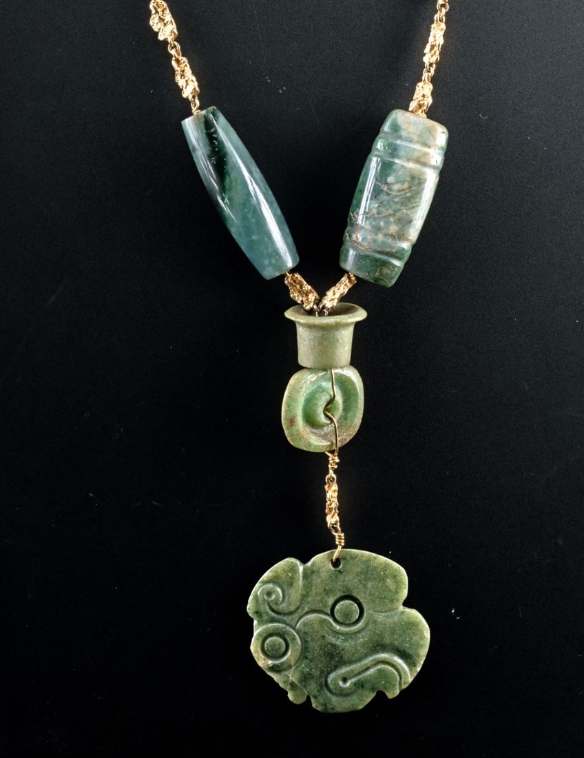 14kt Gold Necklace w/ Pre-Columbian Jade Pendants: Pre-Columbian, Mexico or Guatemala, Maya., ca. 500 - 900 CE. Lovely wearable necklace comprised of 14kt gold chain and 5 authentic Maya jade adornments. The central pendant is a Maya jade raptor in pr