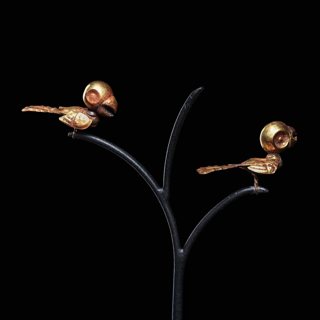 Frias Gold Parrots on Stand (2): Frias, North Coast, ca. 500 BCE. Matching pair of sheet gold and hollow hammer molded parrots having large round heads and multi-piece sheet gold constructed bodies, with long tails having relief dot 
