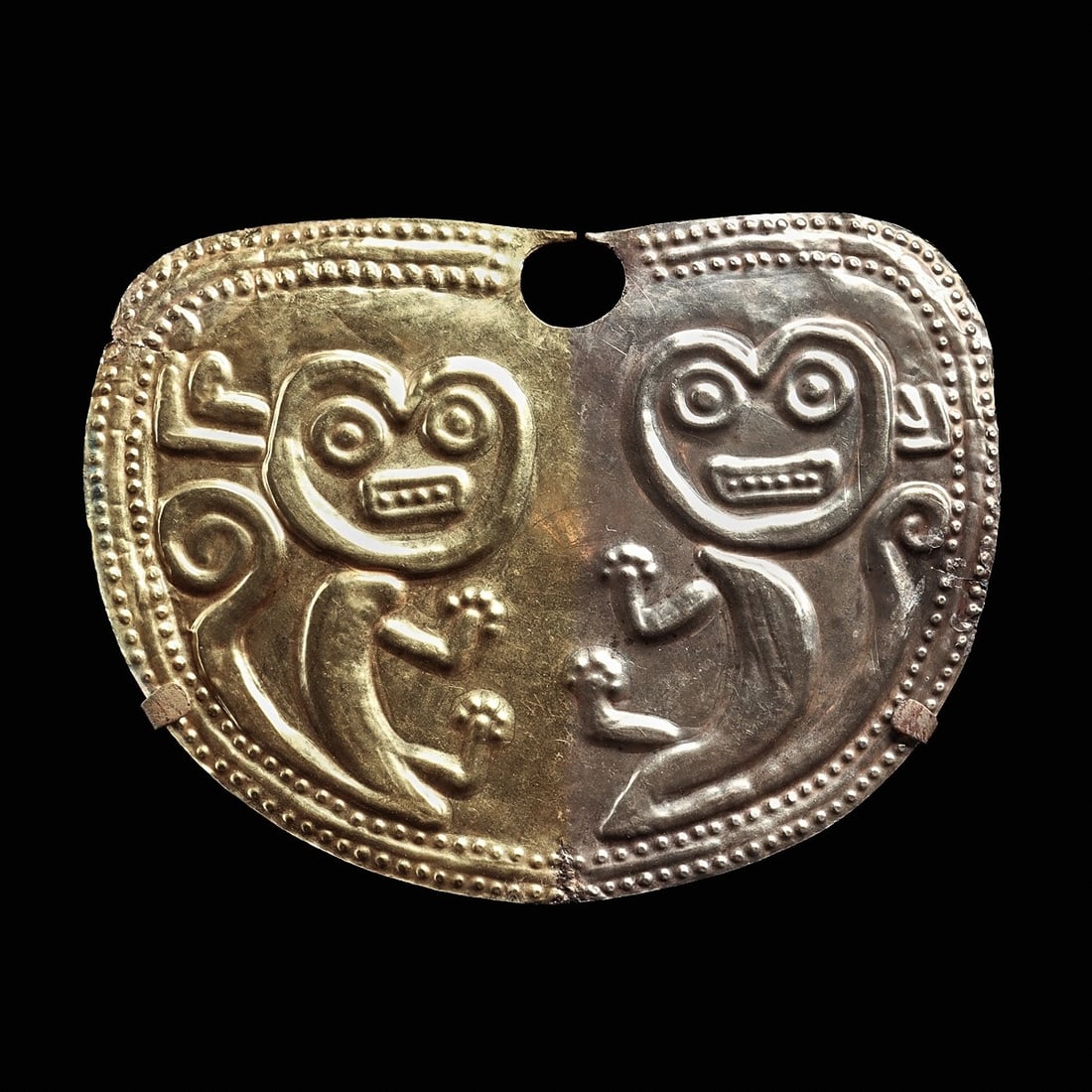 Moche Gold & Silver Nose Ornament: Loma Negra., ca. 100 BCE - 100 CE. Large sheet gold and silver nose ornament, relief decoration depicting two stylized jaguars sitting in presentation, head turned to the front, long curled tails, lar