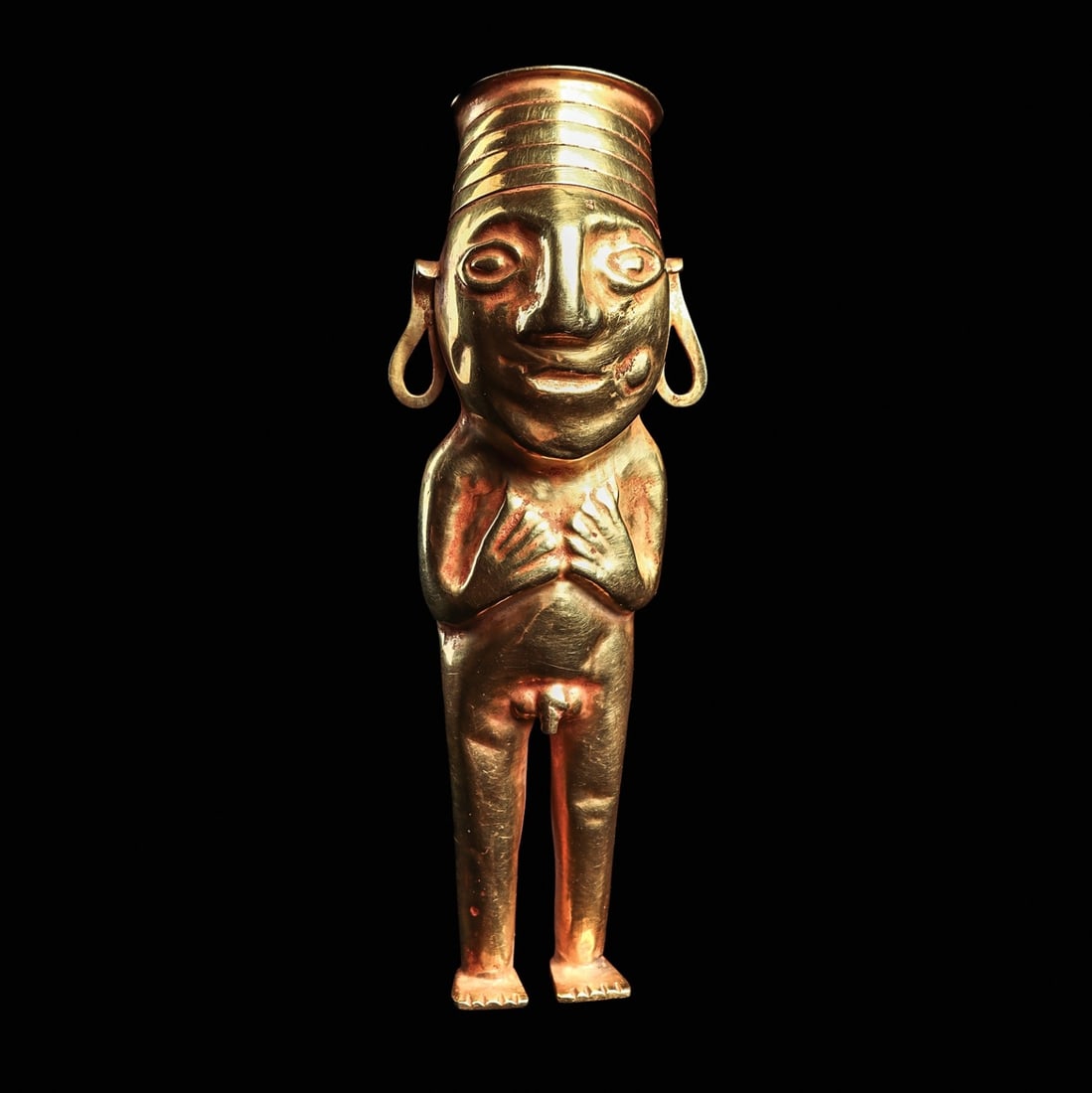 Inca Gold Standing Male Coca Chewer: Inca Empire, ca. 1200 - 1425 CE. Fine and large heavy sheet gold standing coca chewer figure, constructed in the round, holding both hands to his chest, wearing a tall slightly tapered round hat with 