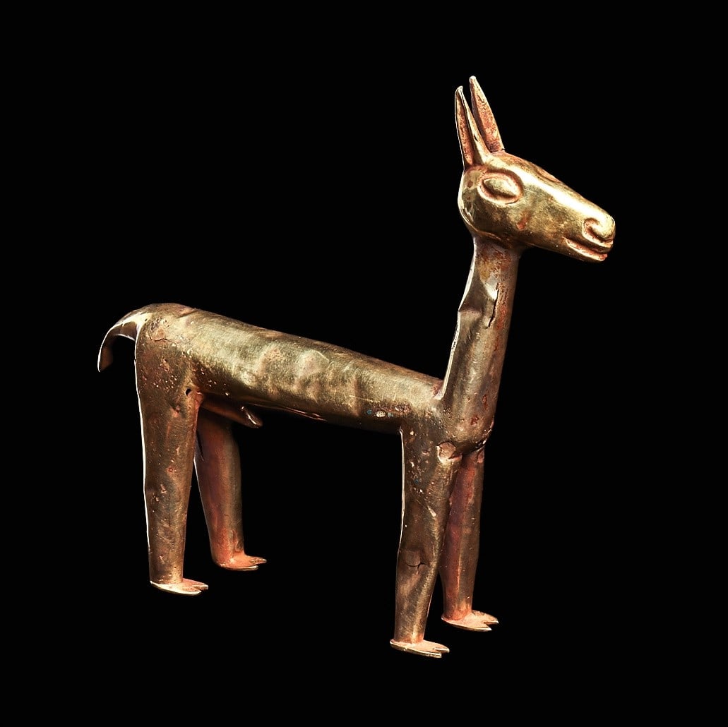Inca Gold Standing Llama: Inca Empire, ca. 1200 - 1425 CE. Standing male llama of tubular form, constructed of multi piece heavy sheet gold, having a short curved pointed tail and long perked ears, large ovoid eyes, feet with 