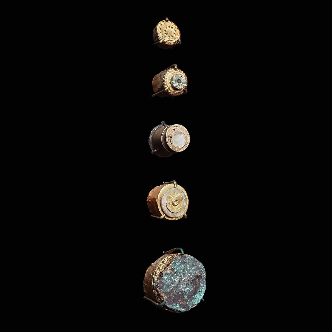 Moche Gold & Silver Labrets (5): Moche, ca. 100 BCE - 100 CE. Group of five different gold labrets, in various sizes, of cylindrical form. The largest is composed of a wide gold band with a beaded edge and set with a thick copper dis