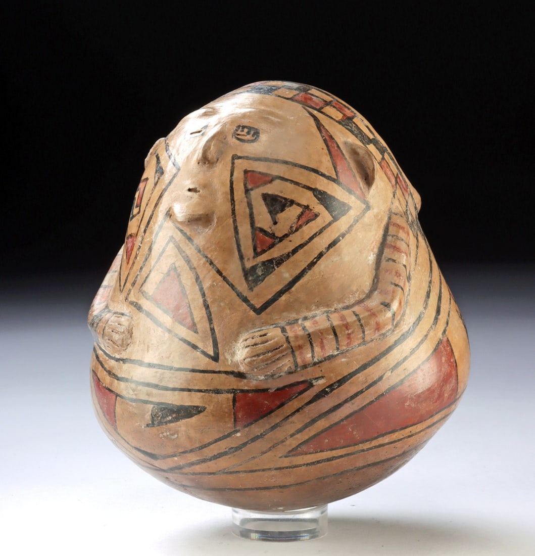 Casas Grandes Polychrome Figural Effigy Pot: Pre-Columbian, Northern Mexico/Southwest, Casas Grandes (Paquime)., ca. 1150 - 1450 CE. A pear-shaped effigy jar in which vessel and figure have been fused into a single compact, top-heavy form with t