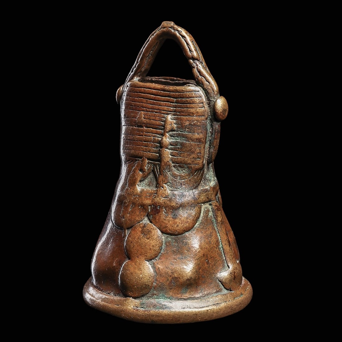 Bronze Bell: Burkina Faso, 19th century. Well handled old bronze bell with abstract relief decoration, now softened from extensive handling, though elements of the original pattern remain visible.4.25”H