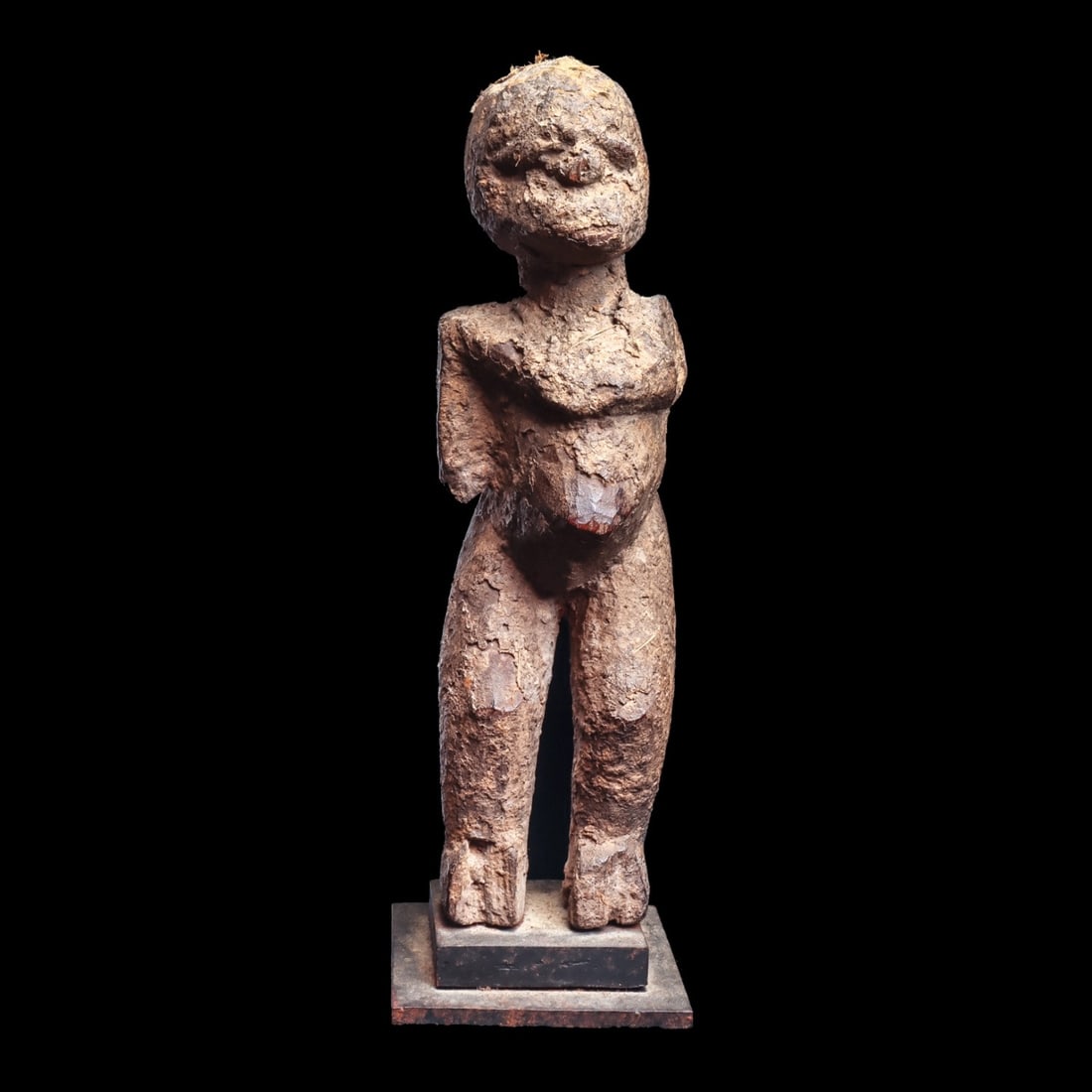 Bateba Figure: Burkina Faso, . Covered with encrusted libations, the figure stands on elongated and separated legs, bearing thick torso with pointed abdomen, and with head turned slightly off to side. Custom