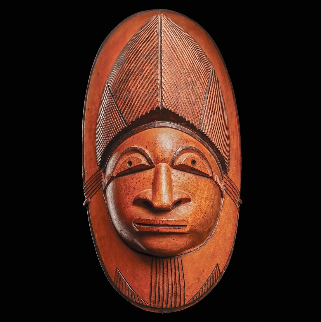 Lobi Mask by Sikire Kambire: Burkina Faso, ca. 1930’s.. Attributed to Sikire Kambire (1896-1963), the finely carved mask with an animated facial expression, crowned by a tall peaked coiffure. The face features large