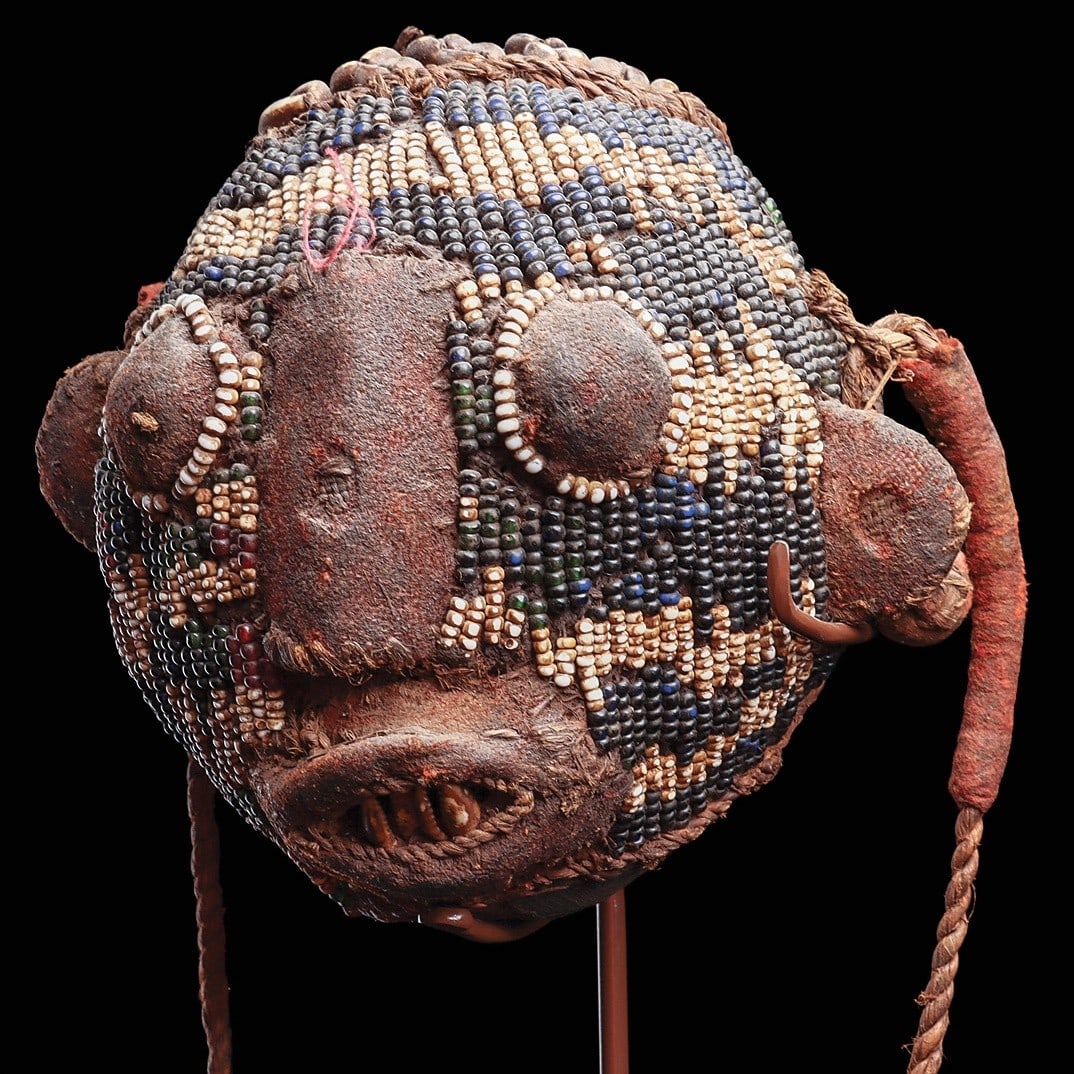Bamileke Beaded Trophy Head: Cameroon, . Worn by chiefs and other notables on ceremonial occasions, this spherical pendant in form of an anthropomorphic head is embroidered with glass beads, modeled with attached fabric ears,