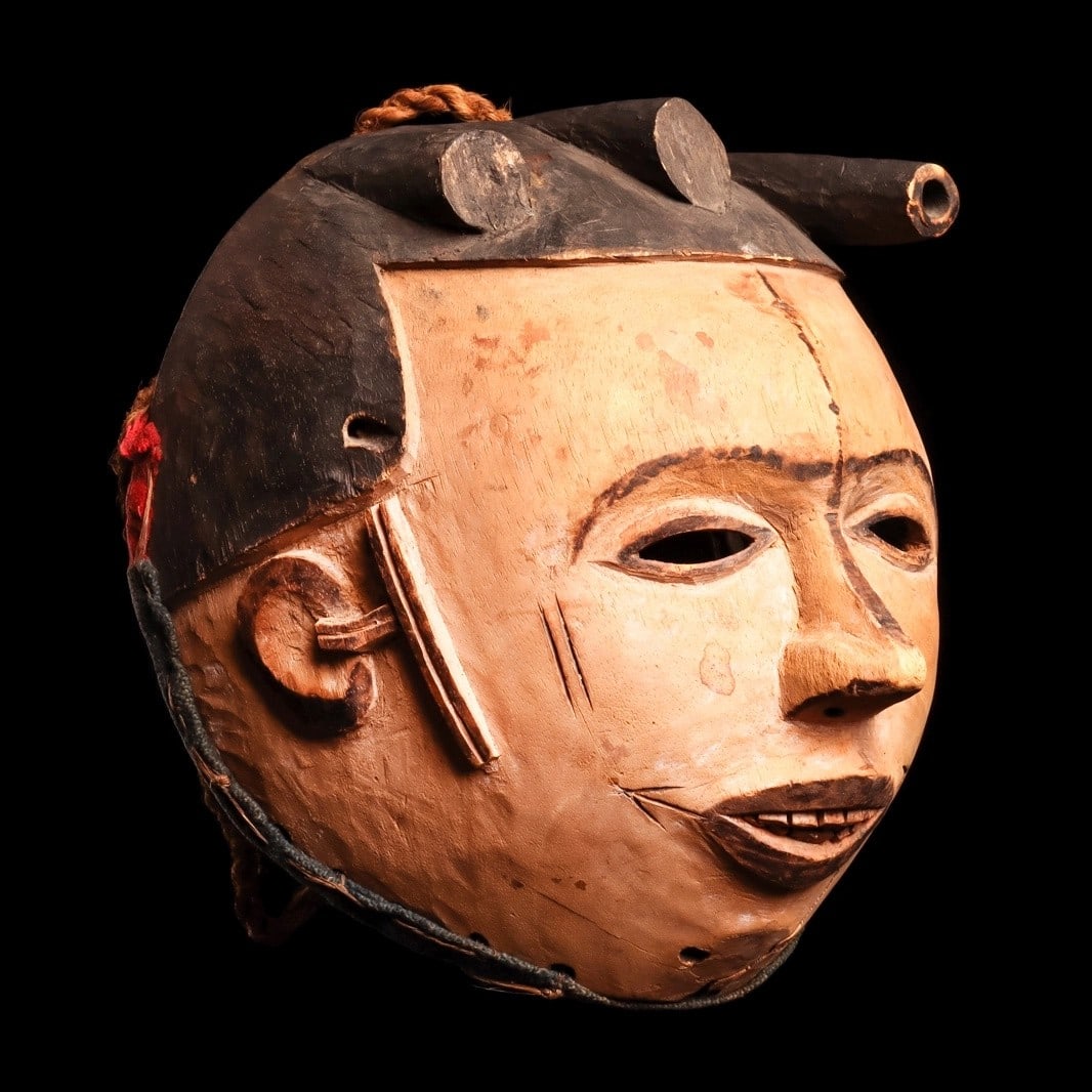Igbo Mask: Nigeria, . Finely carved and deeply hollowed, headdress with three projections. The face is detailed with inserted cane teeth, relief-carved scarification before the ears, and delicate incised scarifi