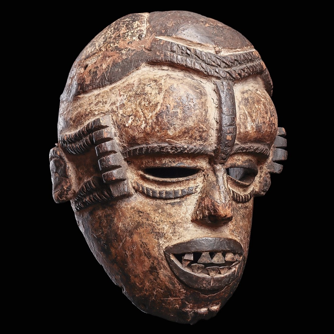 Idoma Mask (Boki): Nigeria, . Good old mask of rounded form. The bulging forehead bisected by notched ridge connecting to wedge nose, with open oval eyes, and temples adorned with thick relief ridges. The open thick lip
