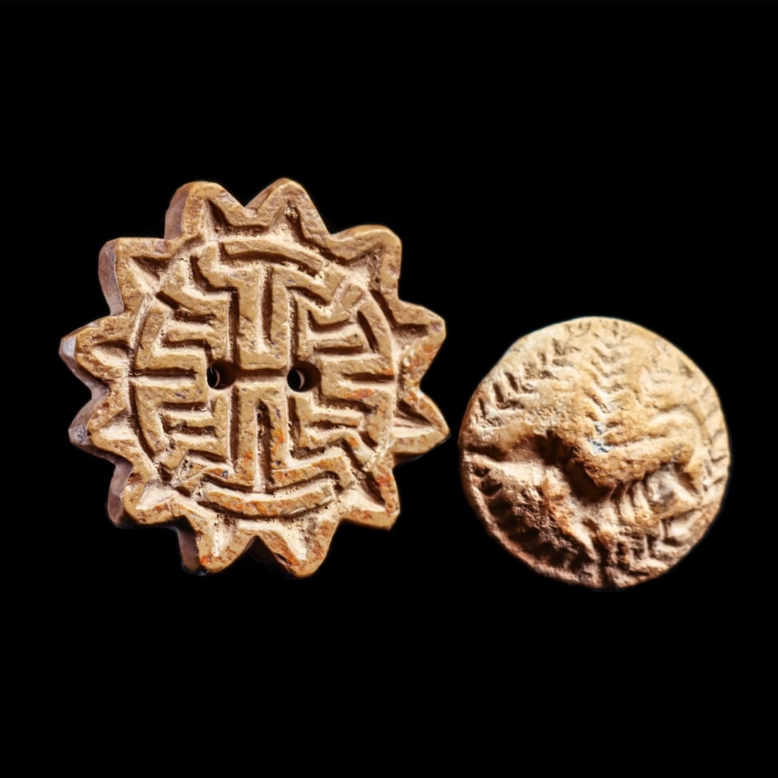 Indus Valley Stamp Seals (2): Mojeno Daro, India, mature Harappan period, ca. 2800 - 2500 BCE. Two different examples including a carved burnt steatite stamp seal bead. Obverse: leaping stag surrounded by sheafs of grain. Reverse 