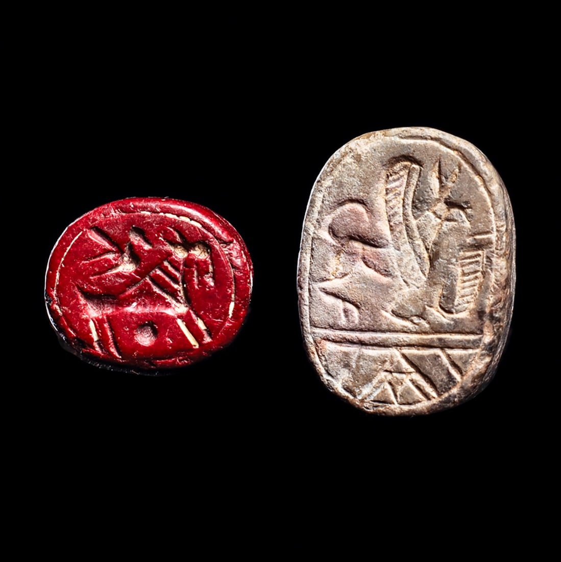 Neo-Assyrian / Phoenician Scaraboid Stamp Seals (2): Phoenician & Neo-Assyrian, ca. 9th - 7th century BCE. Large gray stone Phoenician scaraboid has a stamp impression depicting a winged griffin with a “mythical creature with the body, hind legs, 