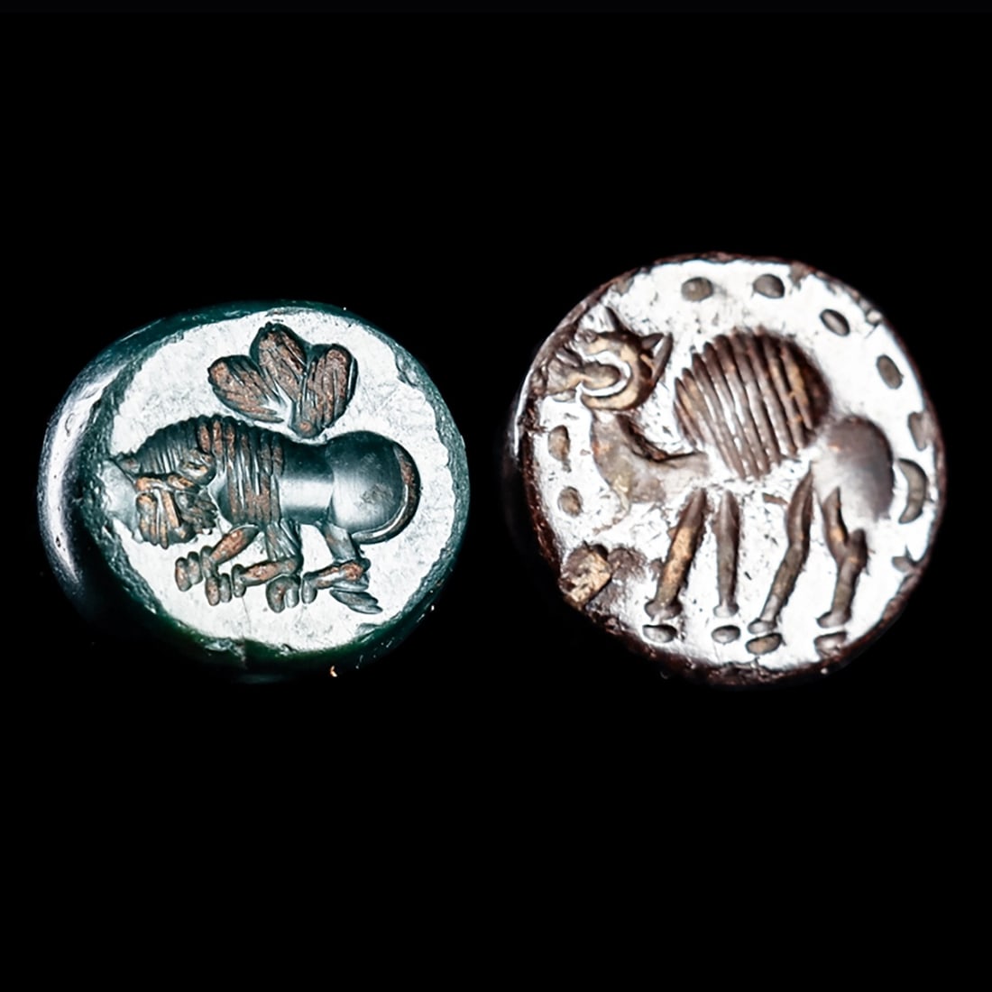 Sasanian Stamp Seals (2): Sasanian Empire. Western Asia, ca. 5th - 6th century CE. Two different stamp seals including a green jasper example having a carved impression depicting a lion with three leaves above his back. Togeth