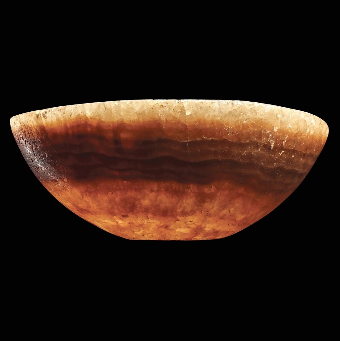 Ancient Middle Eastern Banded Alabaster Bowl: Probably Bactria or Egypt, ca. 2nd to 1st millennium BCE. Carved crystallized, banded alabaster bowl having strong bands in shades of brown and tan. Most likely designed to contain precious liquids an