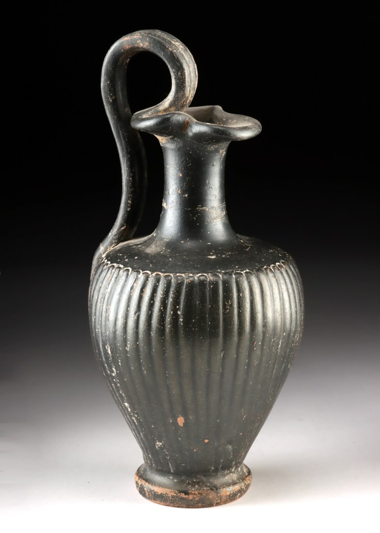 Etruscan Hellenistic Blackware Trefoil Oinochoe: Southern Europe, Italy, Etruria, Hellenistic period., ca. 400 - 201 BCE. A wine jug of disciplined elegance, this Etruscan black-glaze oinochoe belongs to the distinguished tradition of Volterran
