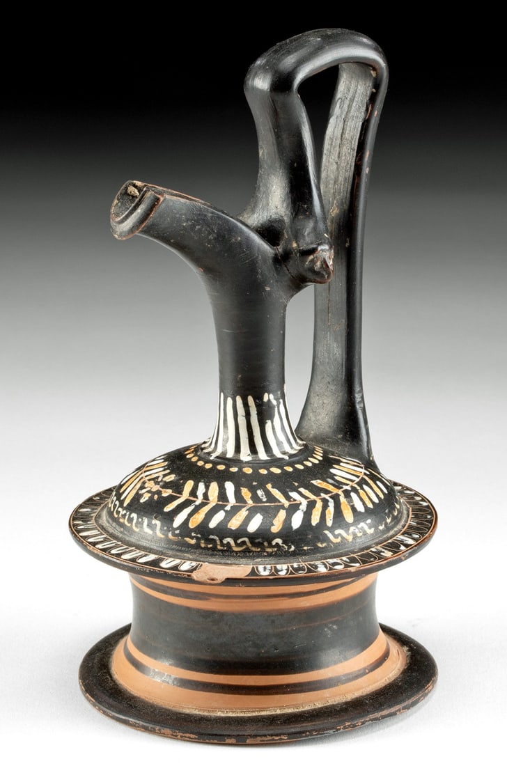 Greek Gnathian Polychrome Epichysis Laurel Motif: Magna Graecia, Southern Italy, Apulia, near Ignazia., ca. 340 - 325 BCE. A beautiful pottery pouring vessel known as an epichysis, boasting an elegant form meticulously hand-painted with elaborate