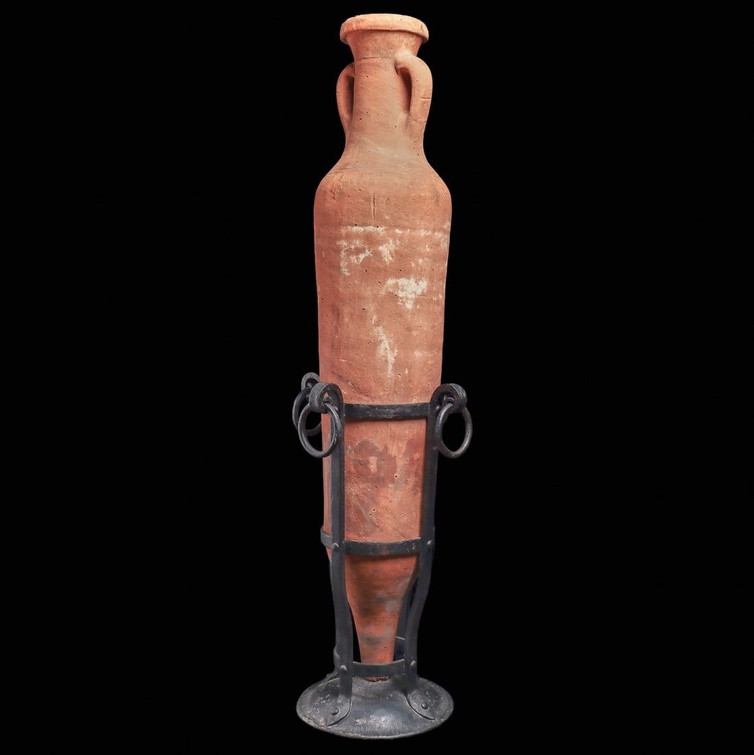 Greco-Roman Terracotta Transport Amphora: Magna Graecia, hellenistic, ca. late 3rd to mid 2nd century BCE. Large orange ware terracotta transport amphora having a slightly tapered cylindrical body terminating to a blunt pointed base, rounded 