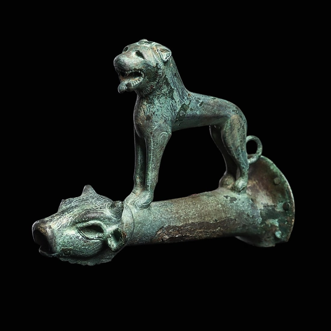 Greek Archaic Bronze Spout with Bull and Lioness: Magna Graecia, ca. late 7th-6th century BCE. Fine cast bronze spout depicting a nicely detailed standing lion on the tapered spout, having a bulls head finial. A rare and beautiful example.3”H