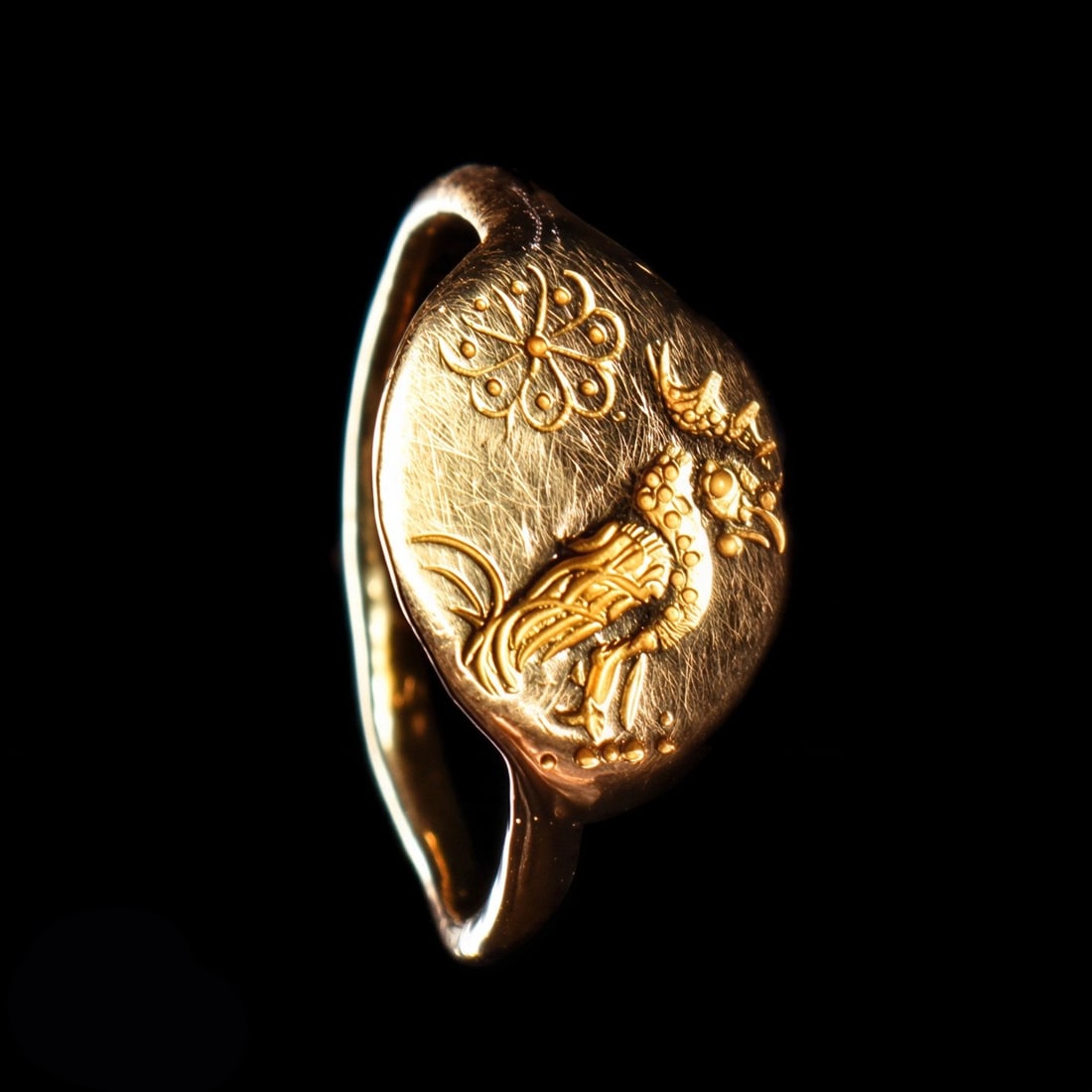 Greek Gold Finger Ring with Rooster: Magna Graecia. Listed as found near Sardes, ca. 6th century BCE. Fine gold finger ring, having a slender tapered shank and flat ovoid face having an engraved decoration depicting a large nicely
