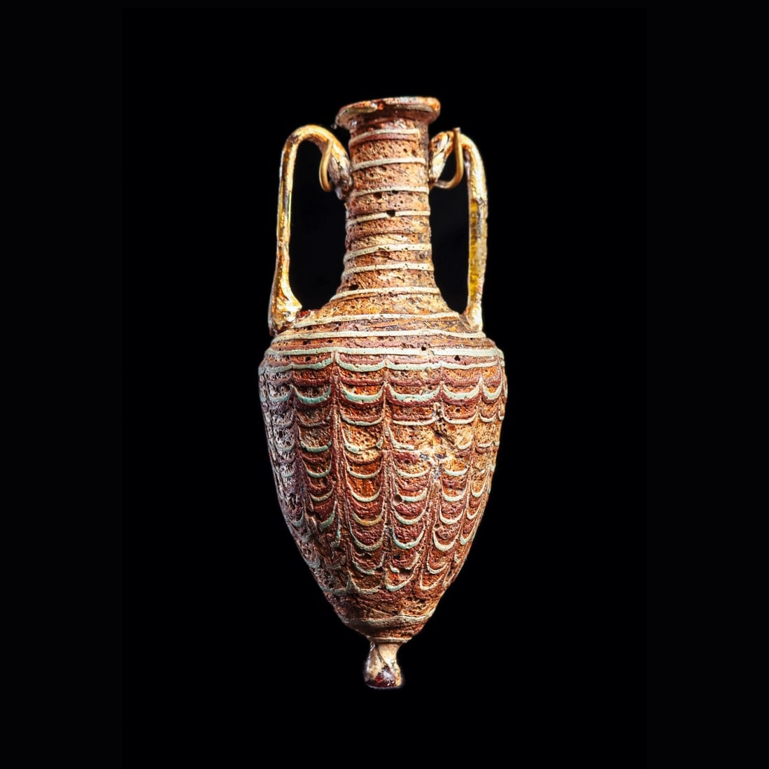 Core-Formed Glass Amphoriskos: Eastern Mediterranean to Middle East, ca. 5th - 4th century BCE. Core-formed glass amphoriskos, having a marvered drapery decorated body in colors of light blue, white and oxidized red-brown. Knob
