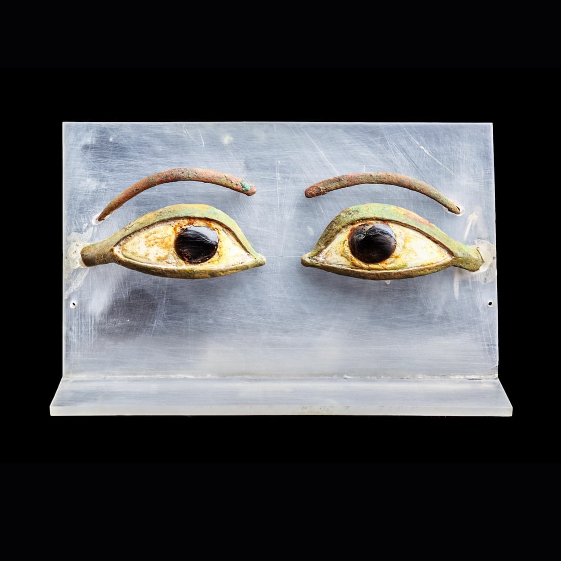 Egyptian Mummy Mask Eyes with Brows: Egypt, middle to Late Period, ca. 1000 - 300 BCE. Matching pair of large bronze eyes with individually cast arched brows, both are inset with a black obsidian iris and carved white stone sclera. Very 
