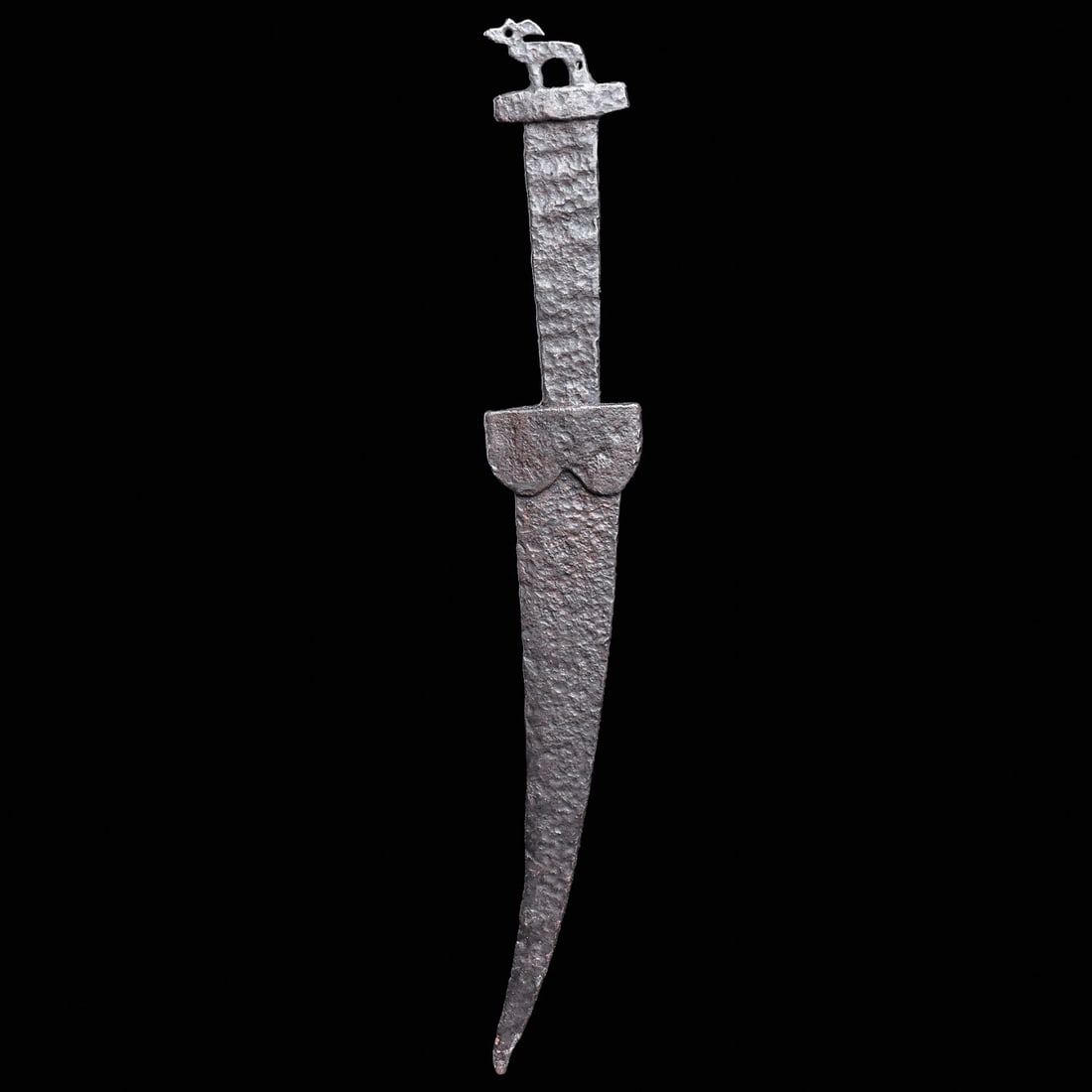 Viking Period Iron Dagger: Eastern Steppes, Southern Europe, ca. 9th - 11th century CE. Hand-forged iron dagger, having a long curved blade, with an applied double lobed hilt guard held with a center rivet, flat rectangular han