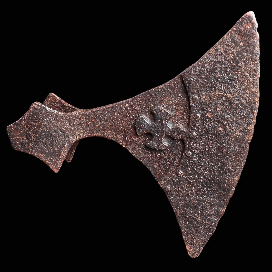Viking Period Iron Battle Axe: Eastern Steppes, Southern Europe, ca. 9th - 11th century CE. Hand-forged iron battle axe, having a wide flared blade, applied double thick reinforced blade attached with seven rivets along the inner e