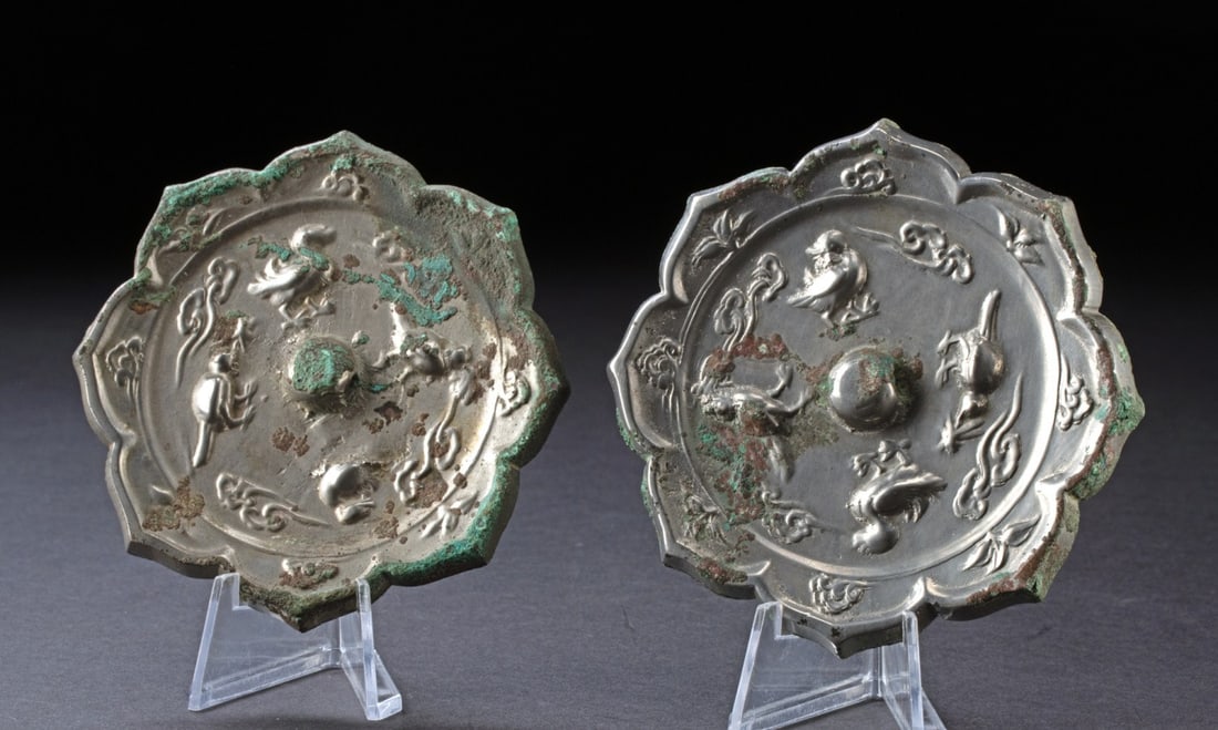 Tang Dynasty 8-Lobed Bronze Mirrors, Auspicious Bird Motifs: East Asia, China, Tang Dynasty., ca. 600 - 999 CE. Two matched eight-lobed bronze mirrors with a high tin content, giving it a bright, silvery luster. The reverse side is intricately decorated with a 