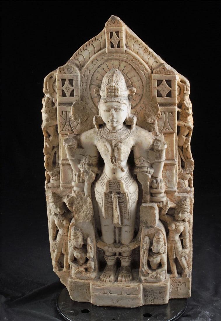 11th C. Indian Marble Vishnu Stele w/ Inscription: South Asia, India, Rajasthan or Gujarat, Solanki (Chaulukya) or Paramara period., ca. 900 - 1199 CE. A rare and finely preserved devotional stele, this four-armed Vishnu stands in rigid samabhanga ato