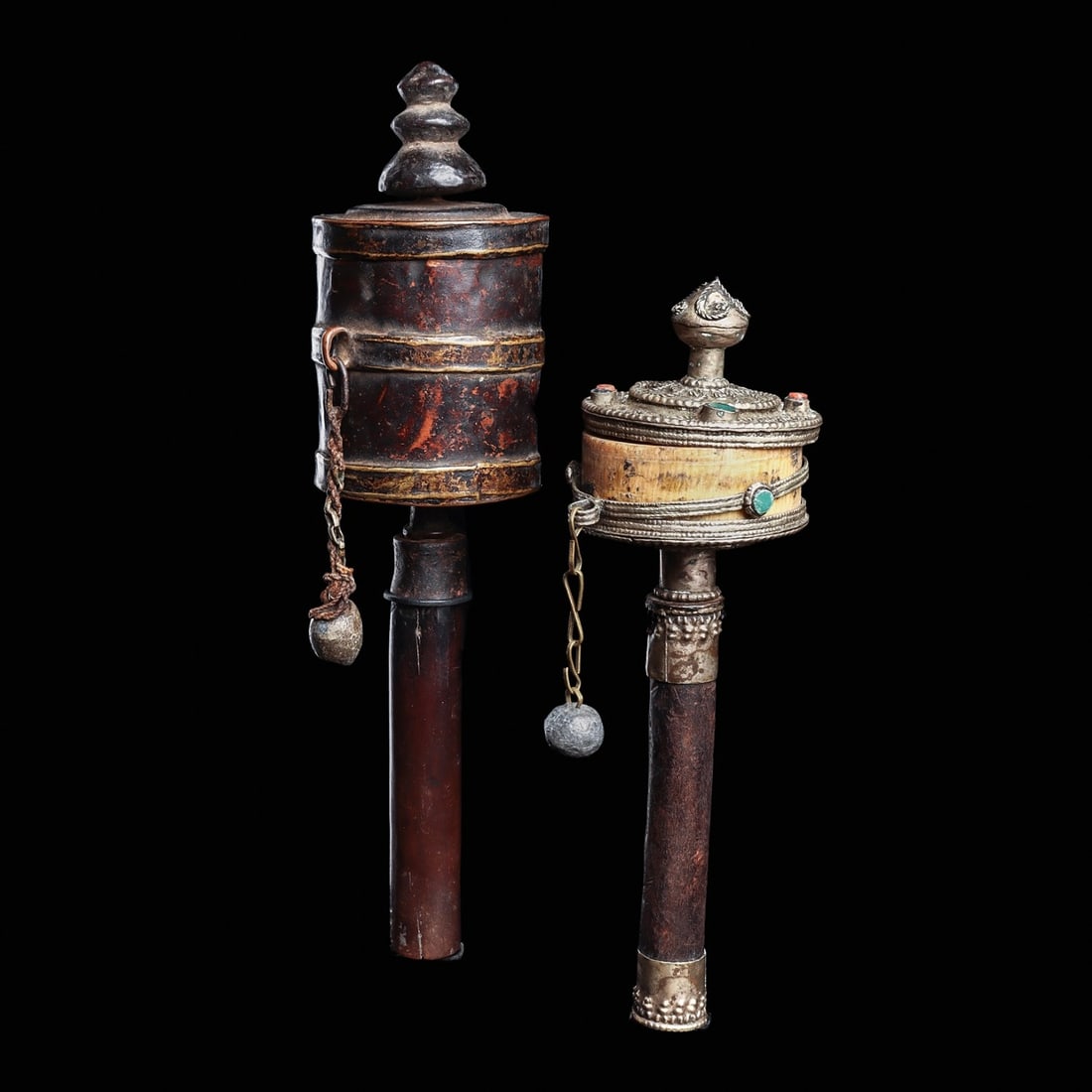 Tibetan Prayer Wheels (2): Tibet, ca. 18th to 19th century. Two different prayer wheels, including a wheel having a bone wheel with a fancy silver filigree cap set with coral and green stones, lower silver cap and silver handle