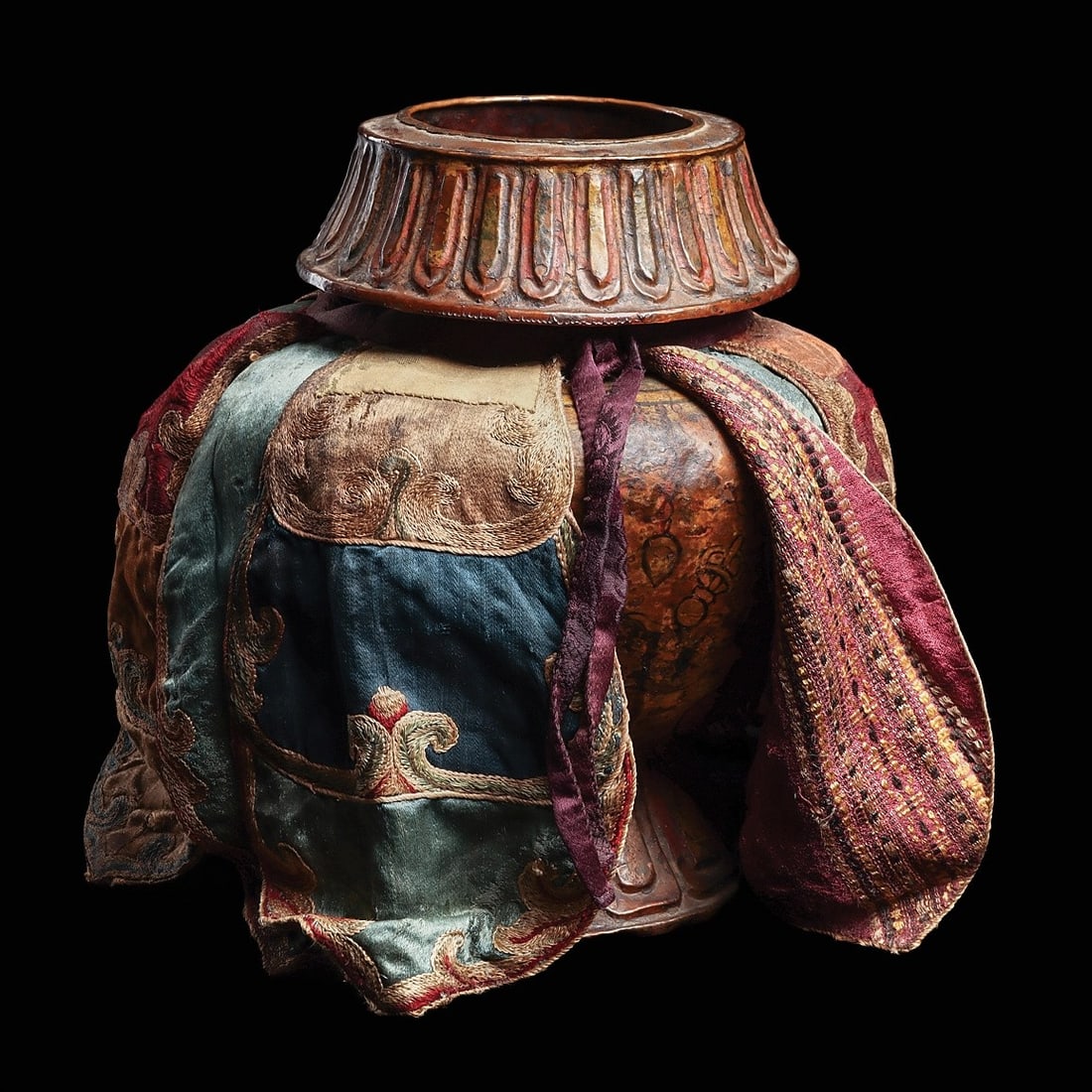 Tibet Bumpha Ritual Water Vessel: Tibet, ca. 18th - 19th century. Large copper vessel, used in Buddhist rituals, of three piece hammered construction, with a wide down folded wide collar rim decorated in relief with stylized lotus pet