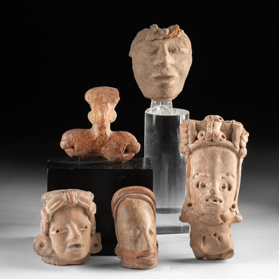 Pre-Columbian Terracotta Heads, Group of 5: Pre-Columbian, Mesoamerica, ca. 300 BCE – 900 CE. A group of five terracotta figural heads and fragments from larger burial or ritual figures, representing several distinct regional traditions i